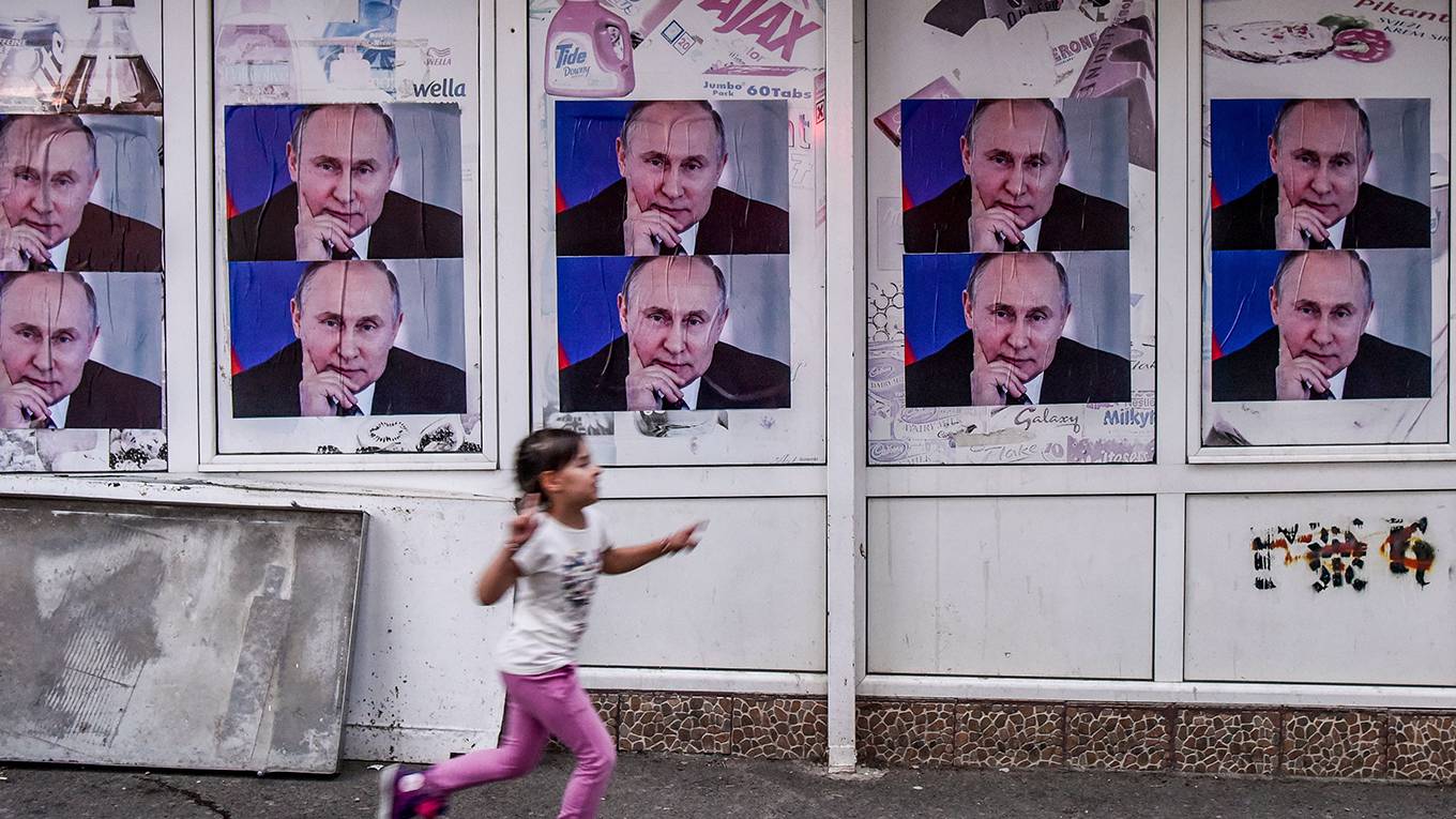 oreshkin1_ARMEND NIMANIAFPGetty Images_putinpostersgirlrunning